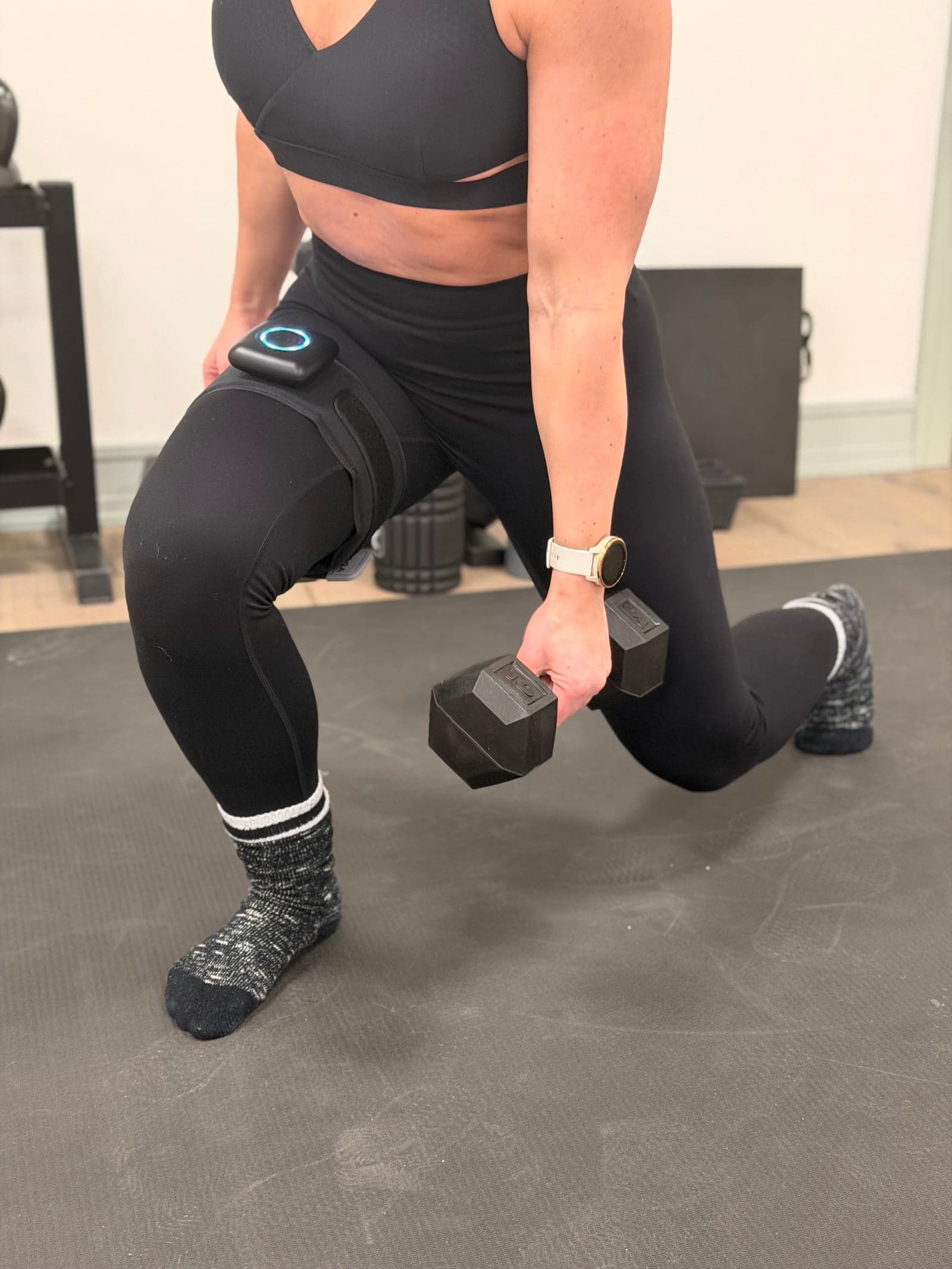 Athlete performing a loaded lunge with a SAGA BFR cuff on the upper thigh at Thera Performance Lab in Lake Orion, Michigan