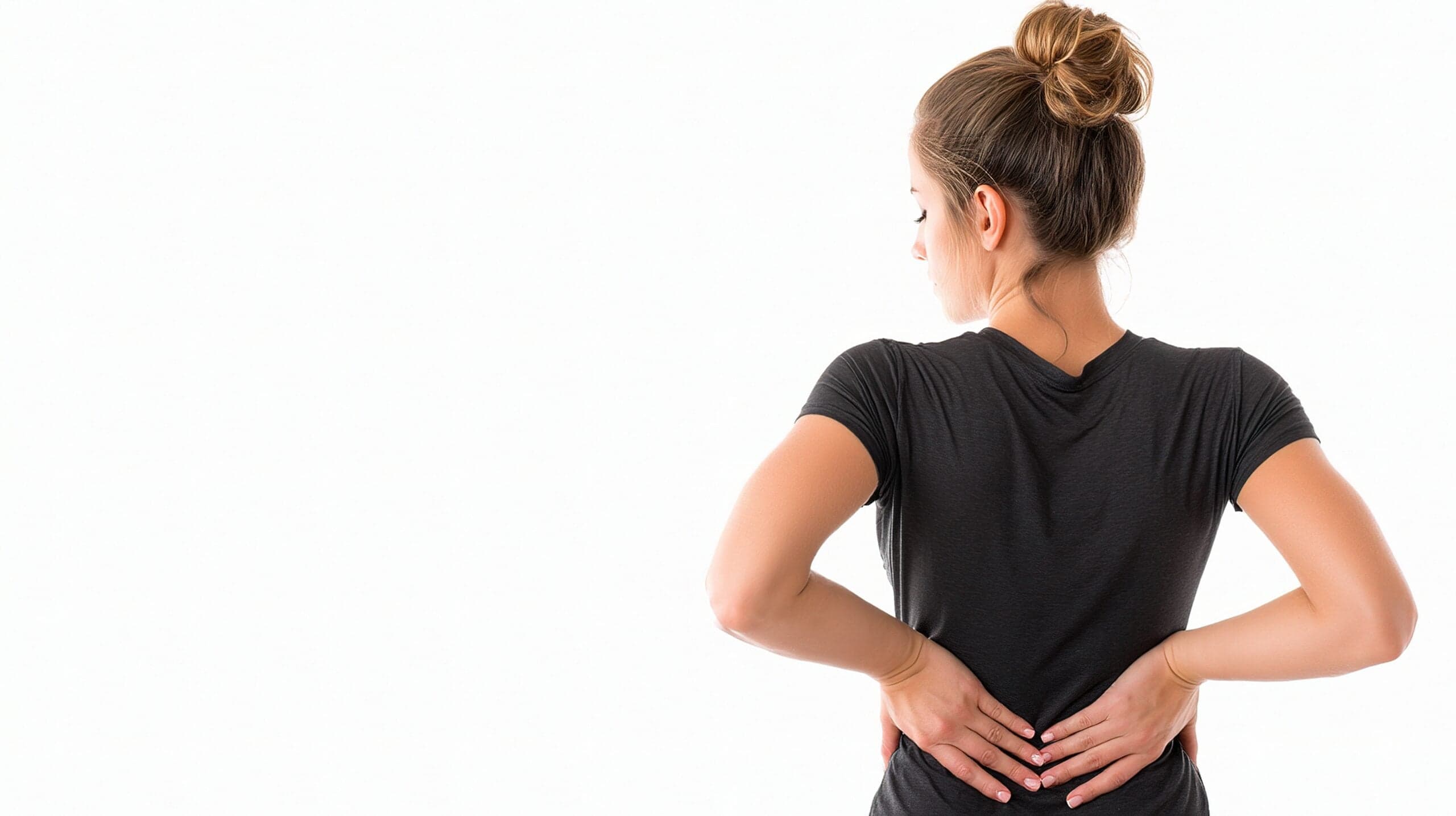 Active adult holding one-sided low back and pelvis pain in Lake Orion, MI