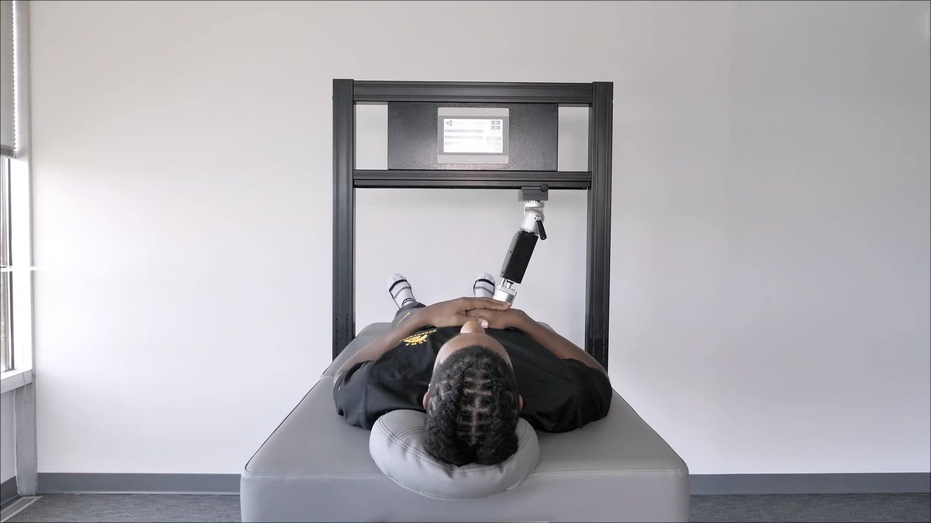 RX2600 robotic arm in use during a sports physical therapy session at Thera Performance Lab in Lake Orion, MI