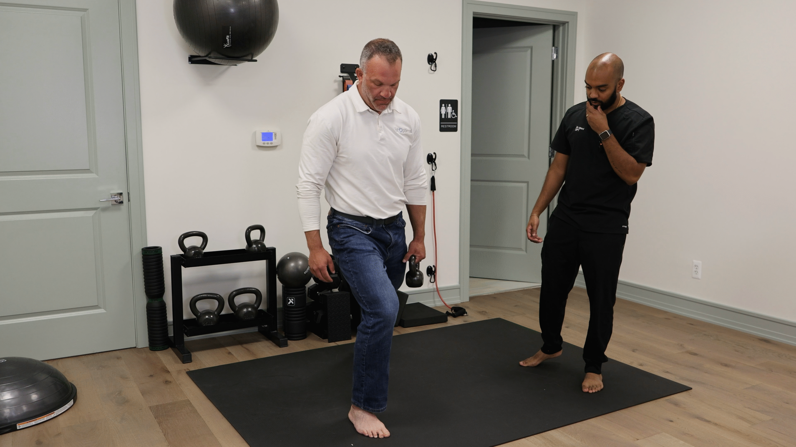 Physical therapist performing a movement evaluation to identify patterns contributing to back pain